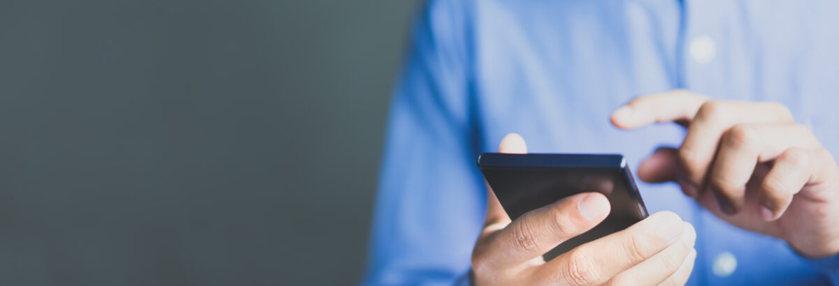 Business man holding his cell phone.