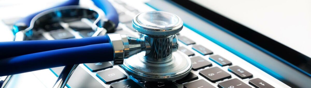 Stethoscope sitting on laptop keyboard.